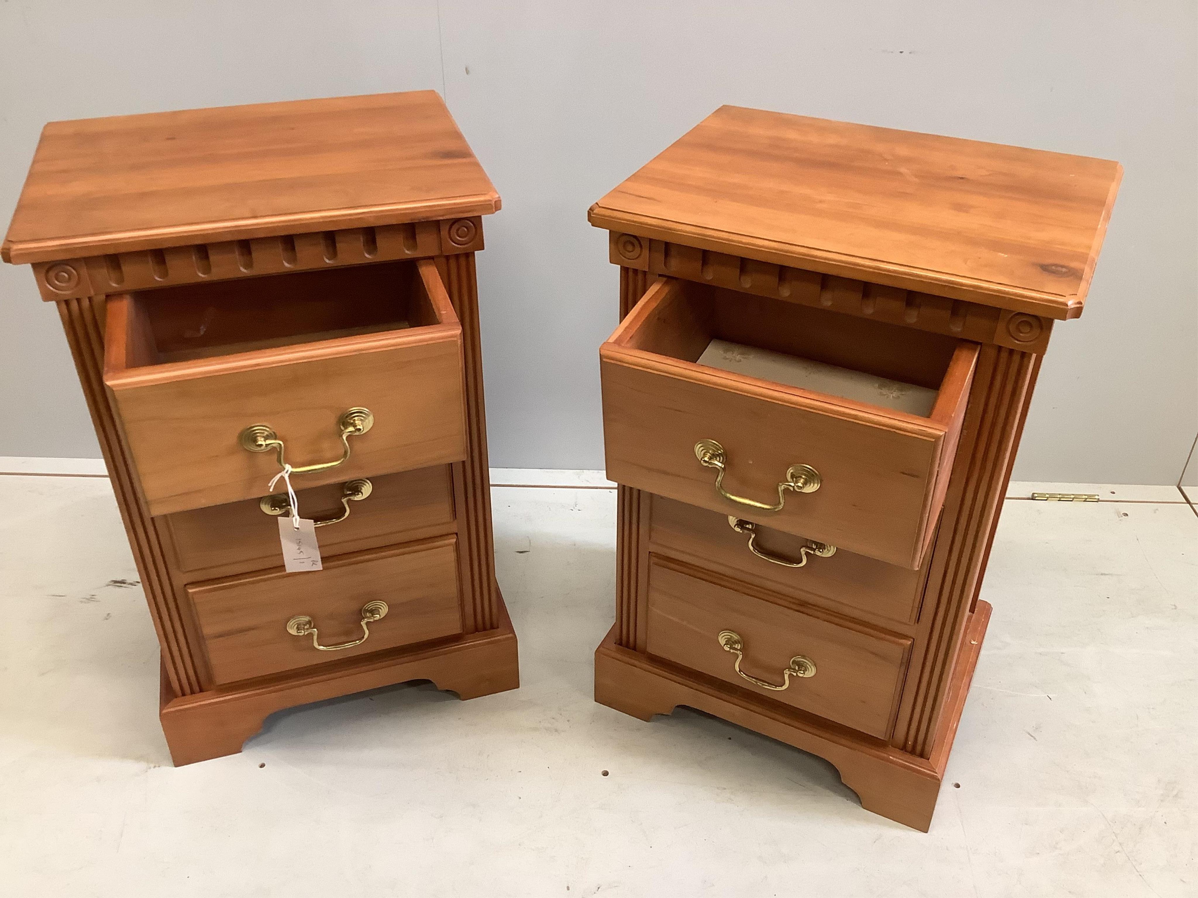 A pair of reproduction cherry three drawer bedside chests, width 45cm, depth 36cm, height 71cm. Condition - fair